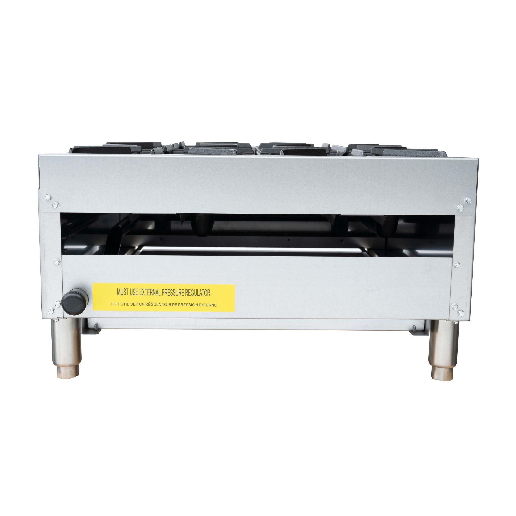 A commercial gas hot plate with a stainless steel body, four black cast iron burner grates on top, and silver legs, featuring a yellow warning label on the front.