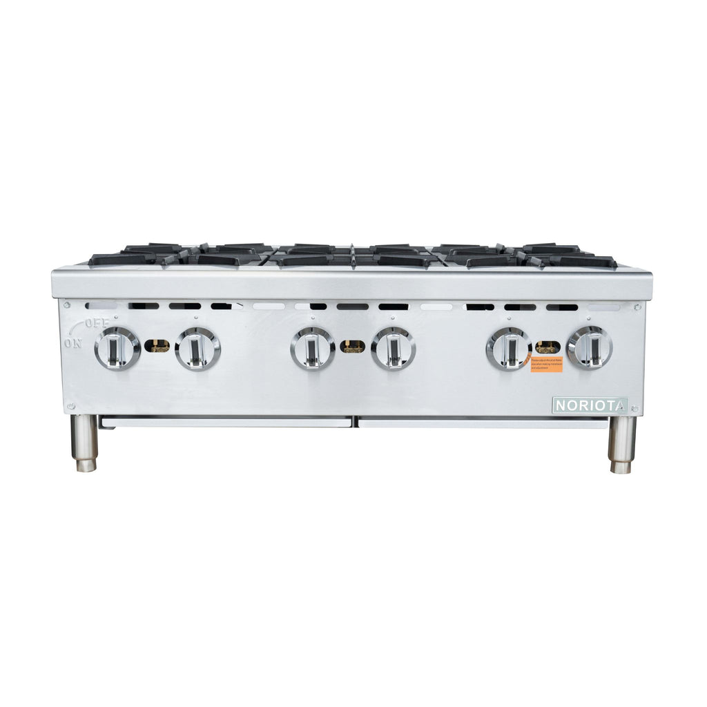 A commercial 6-burner gas hot  plate with a stainless steel body, four front control knobs, and silver legs, shown against a plain white background.