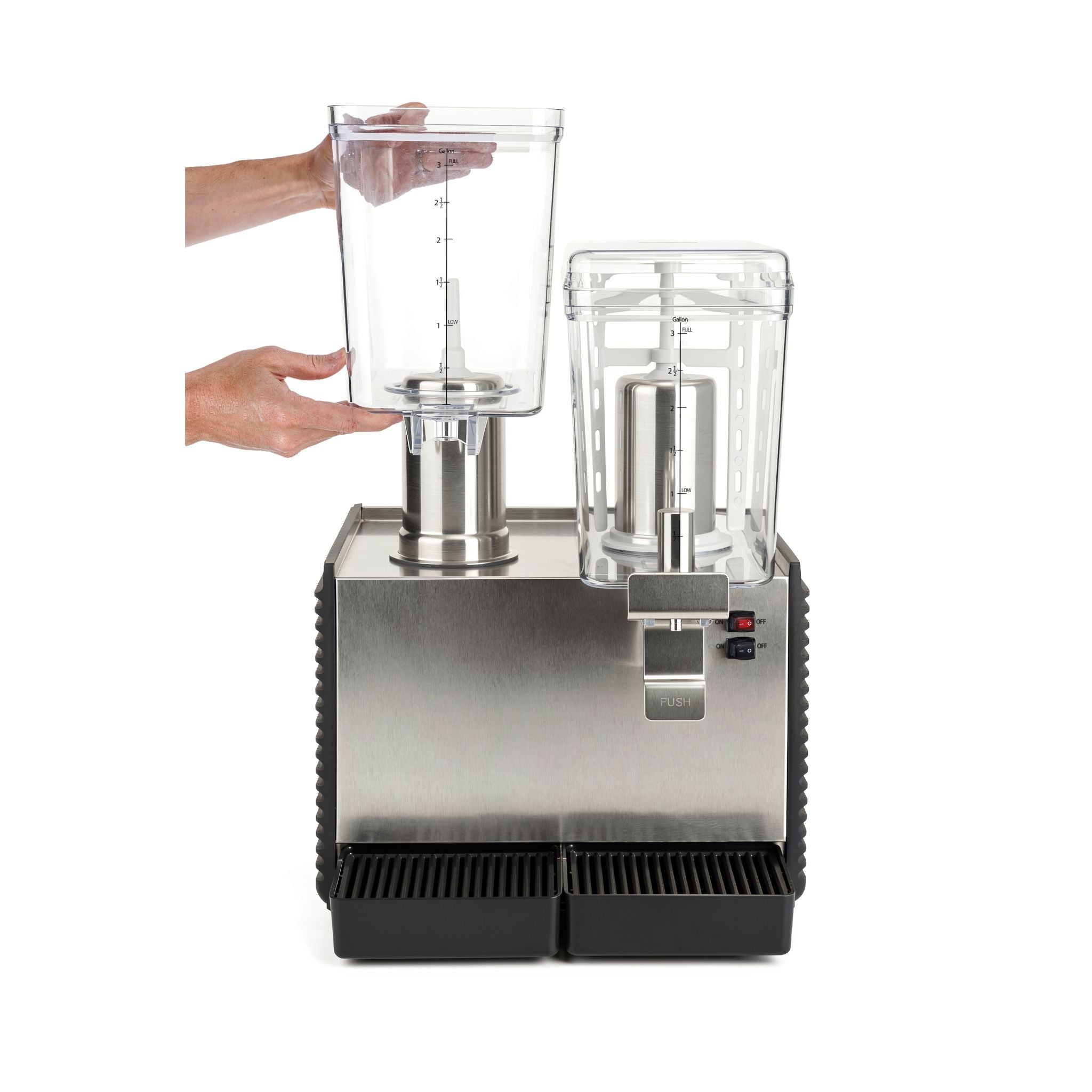 A stainless steel and black commercial beverage mixer with two clear plastic containers, shown with hands inserting one of the containers into the machine on a white background.