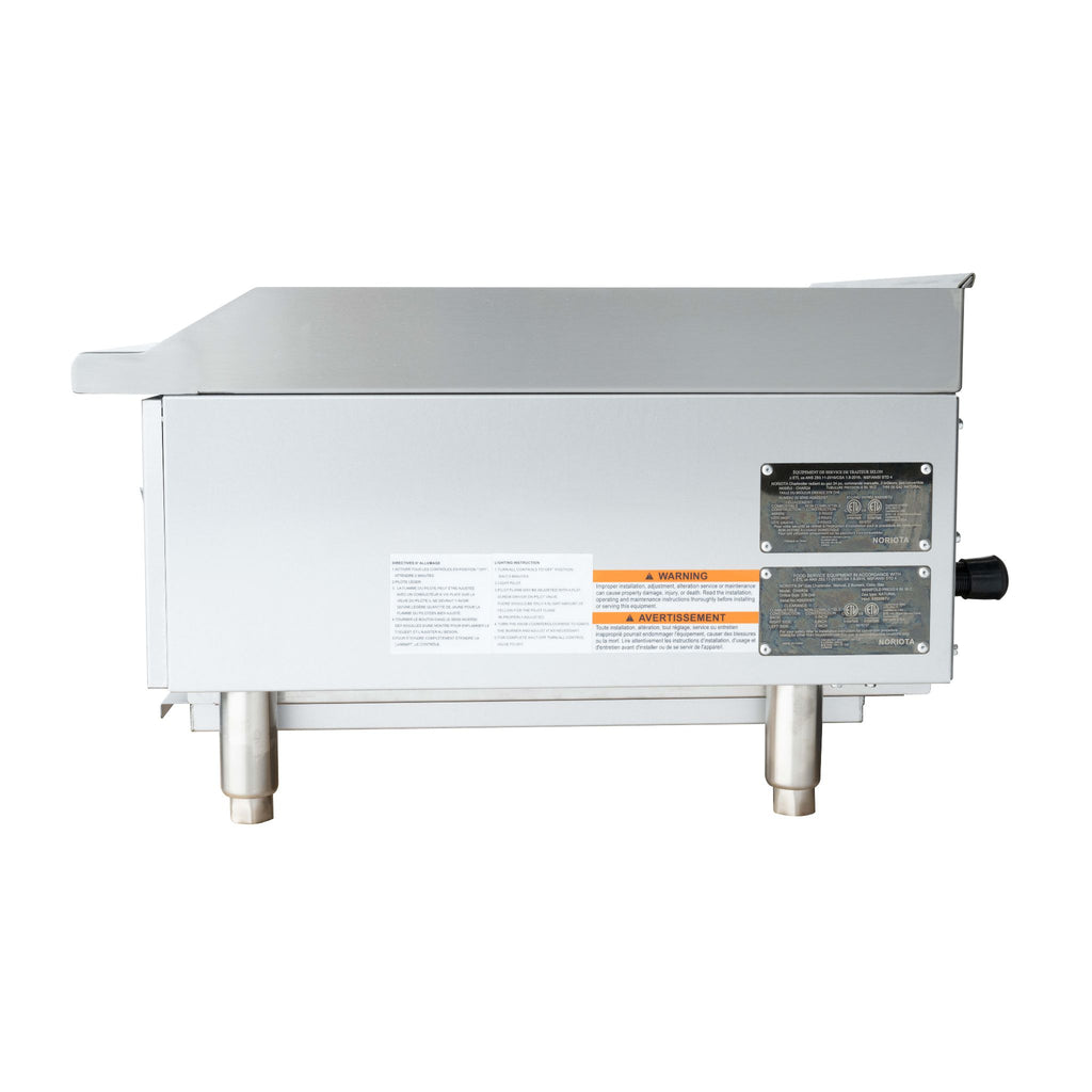 A stainless steel commercial gas grill or charbroiler shown from the side, featuring metal support legs, a black power cord handle, and warning labels on a white background.