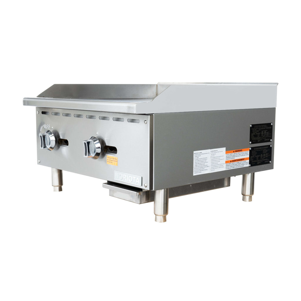 A commercial two-burner gas grill or manual griddle with a stainless steel body, featuring two control knobs on the front, a flat grilling surface, and support legs, shown against a plain white background.