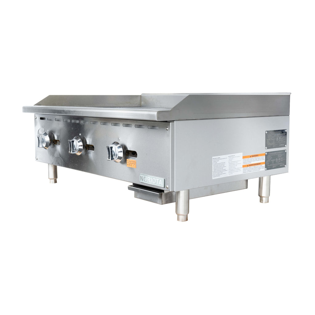 A stainless steel commercial gas flat top grill  or manual gas griddle with three control knobs on the front, standing on four legs against a plain white background.